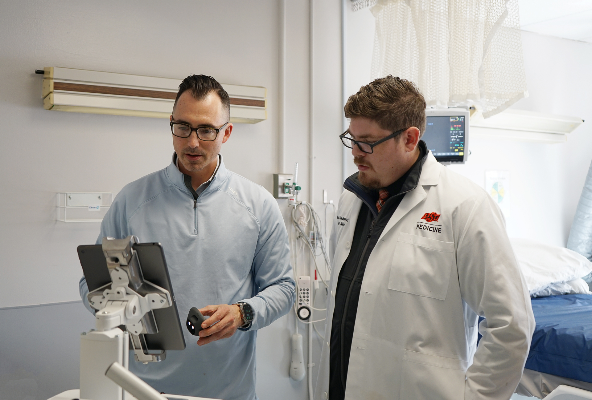 A doctor and patient stand side-by-side in a medical clinic